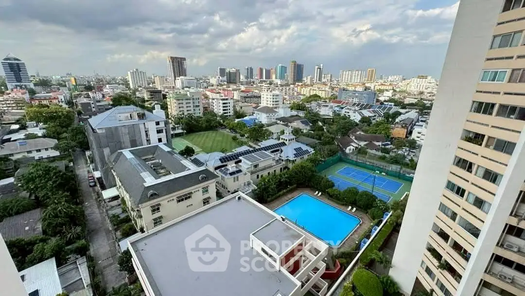 Stunning cityscape view from high-rise building with pool and tennis court