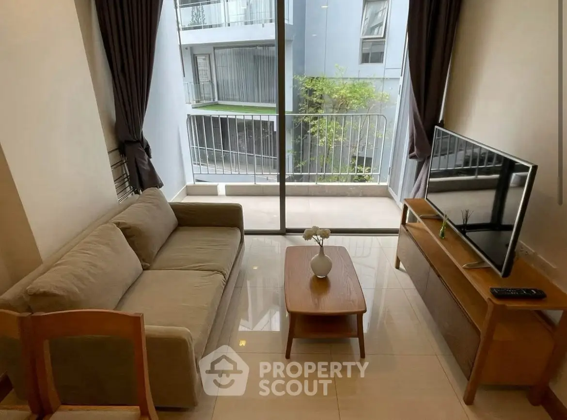 Modern living room with cozy sofa and large window balcony view