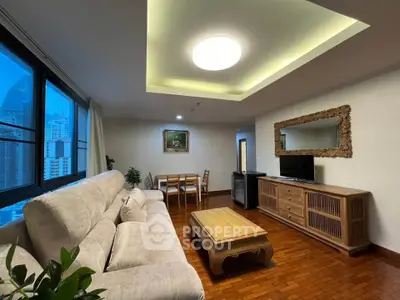 Spacious living room with elegant wooden furniture and city view windows.