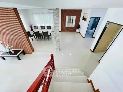 Spacious modern living area with elegant dining setup and stylish decor