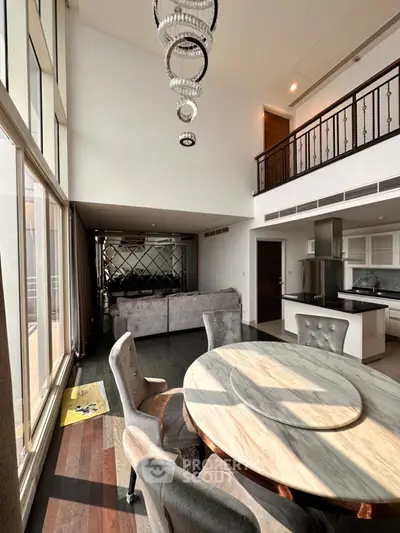 Luxurious open-plan living room with high ceilings and modern kitchen