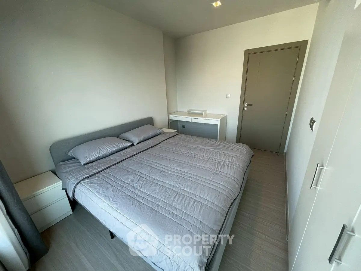 Modern minimalist bedroom with sleek design and neutral tones.