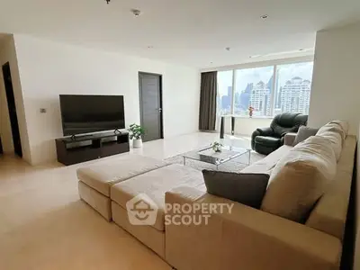 Spacious modern living room with city view, large sofa, and sleek decor.