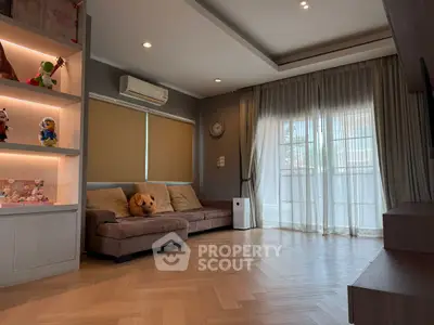 Spacious living room with cozy sofa and large window for natural light