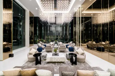Luxurious modern living room with elegant chandeliers and plush seating in a high-end property.