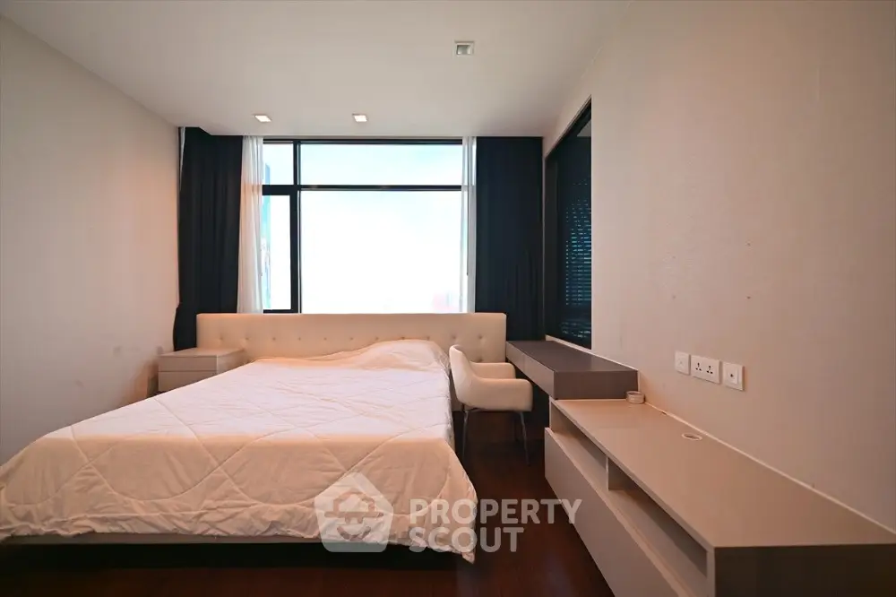 Modern bedroom with large window and minimalist furniture design