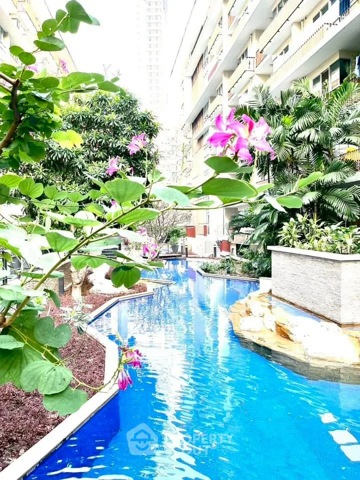 Luxurious residential pool with lush greenery and vibrant flowers