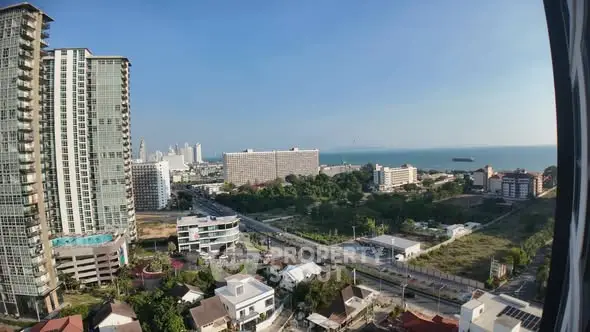Stunning coastal cityscape view with modern high-rise buildings and ocean horizon.