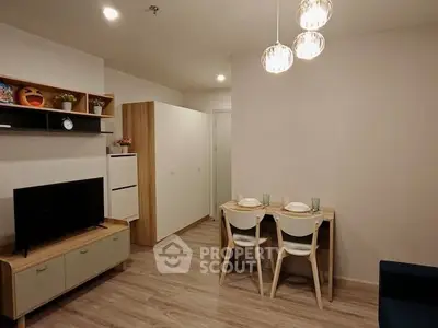 Modern living room with stylish furniture and dining area in a cozy apartment.