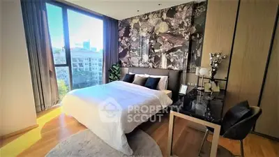 Luxurious bedroom with large window and elegant decor in modern apartment.