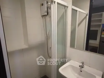 Modern bathroom with shower and sink in a sleek apartment