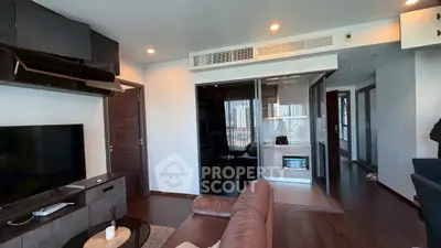 Modern living room with sleek design and integrated kitchen area