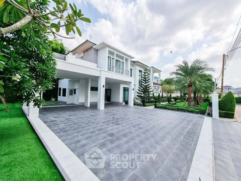 Stunning modern home with spacious driveway and lush landscaping