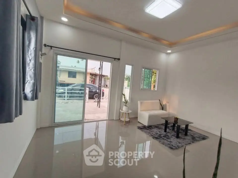 Modern living room with sleek design and large windows for natural light.