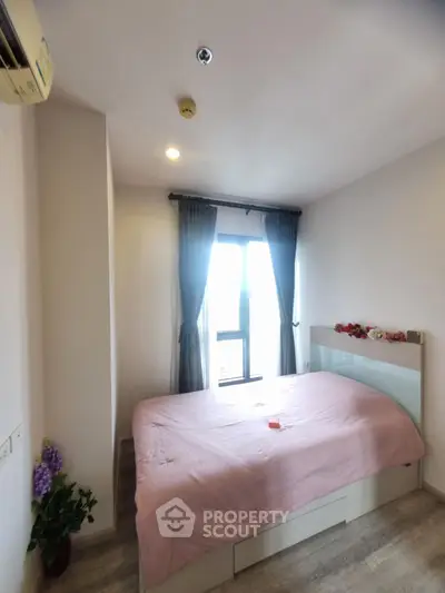 Cozy bedroom with natural light and modern decor, perfect for relaxation and comfort.