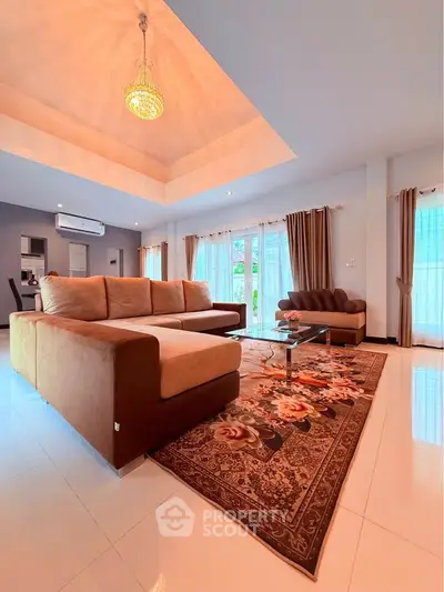 Spacious living room with elegant decor and large windows for natural light