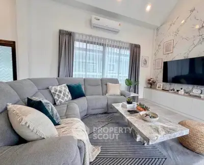 Luxurious living room with modern decor, plush sectional sofa, and elegant marble coffee table.