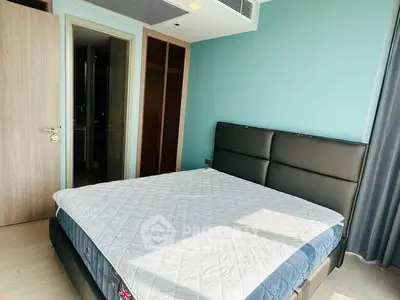 Modern bedroom with stylish bed and natural light in contemporary apartment.