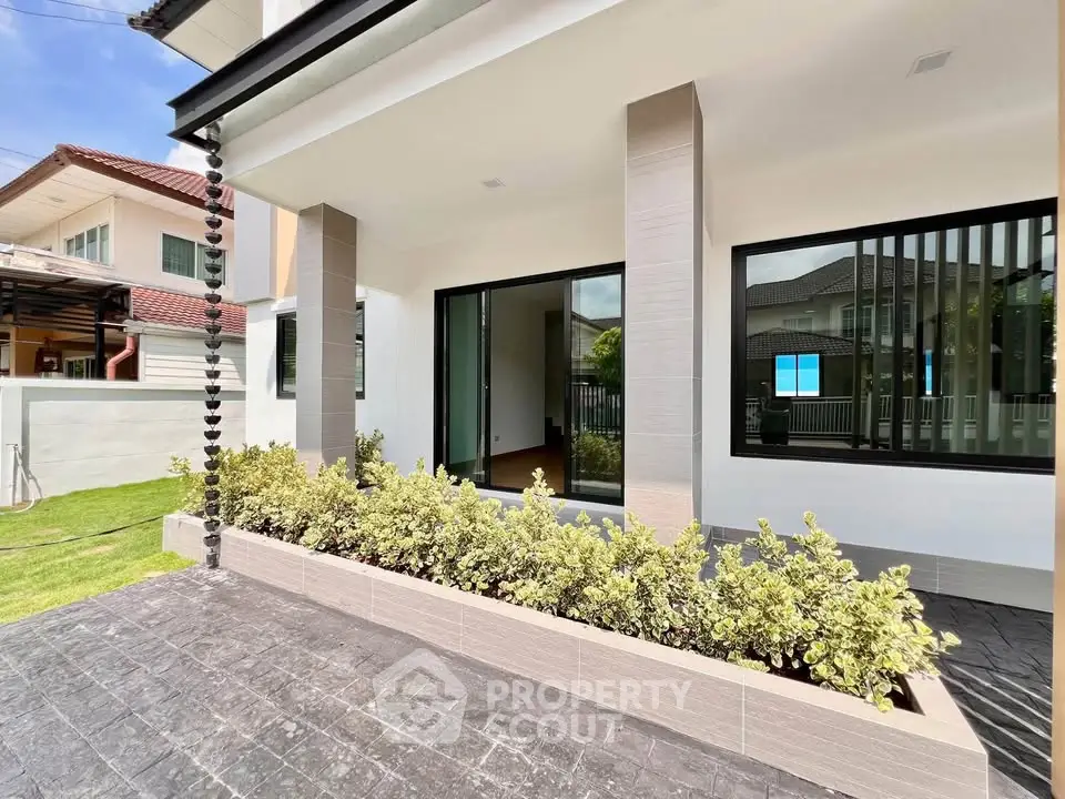 Modern house exterior with landscaped garden and large windows