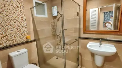 Modern bathroom with glass shower and stylish tile accents