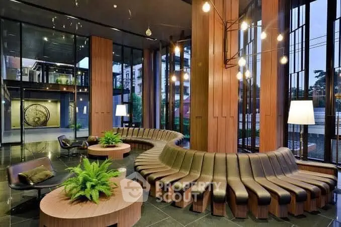 Luxurious modern lobby with unique seating and stylish lighting in upscale building.