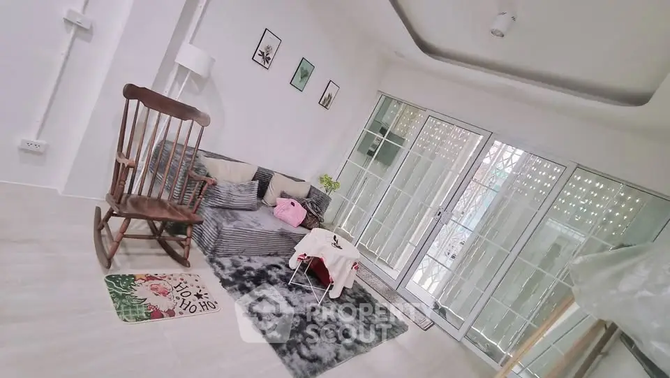 Charming living room with cozy seating and large windows for natural light.