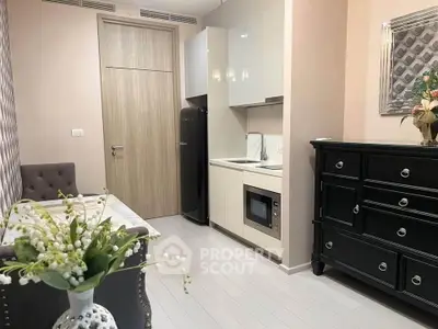 Chic compact kitchen with modern appliances and elegant decor in a cozy apartment setting.