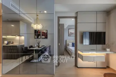 Modern open-plan living and dining area with sleek design and elegant furnishings.