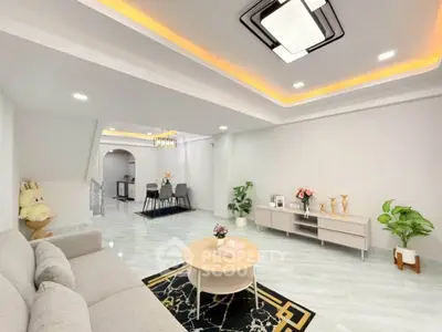 Spacious modern living room with elegant decor and open dining area