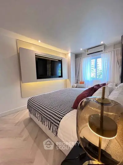 Modern bedroom with stylish decor and large window view