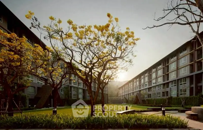 Modern apartment complex with lush garden and trees in serene setting