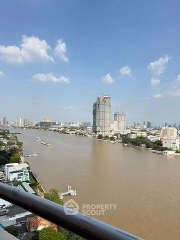 Stunning river view from high-rise balcony with cityscape backdrop, perfect for urban living.