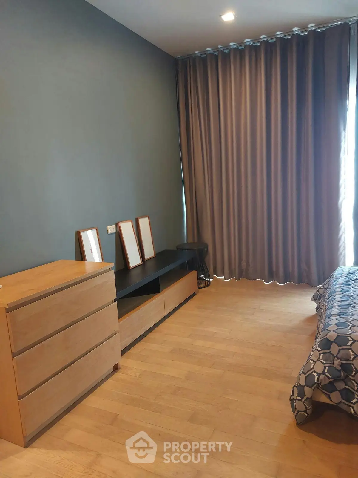 Modern bedroom with wooden flooring and stylish decor