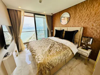 Luxurious bedroom with stunning ocean view and elegant decor in high-rise apartment.