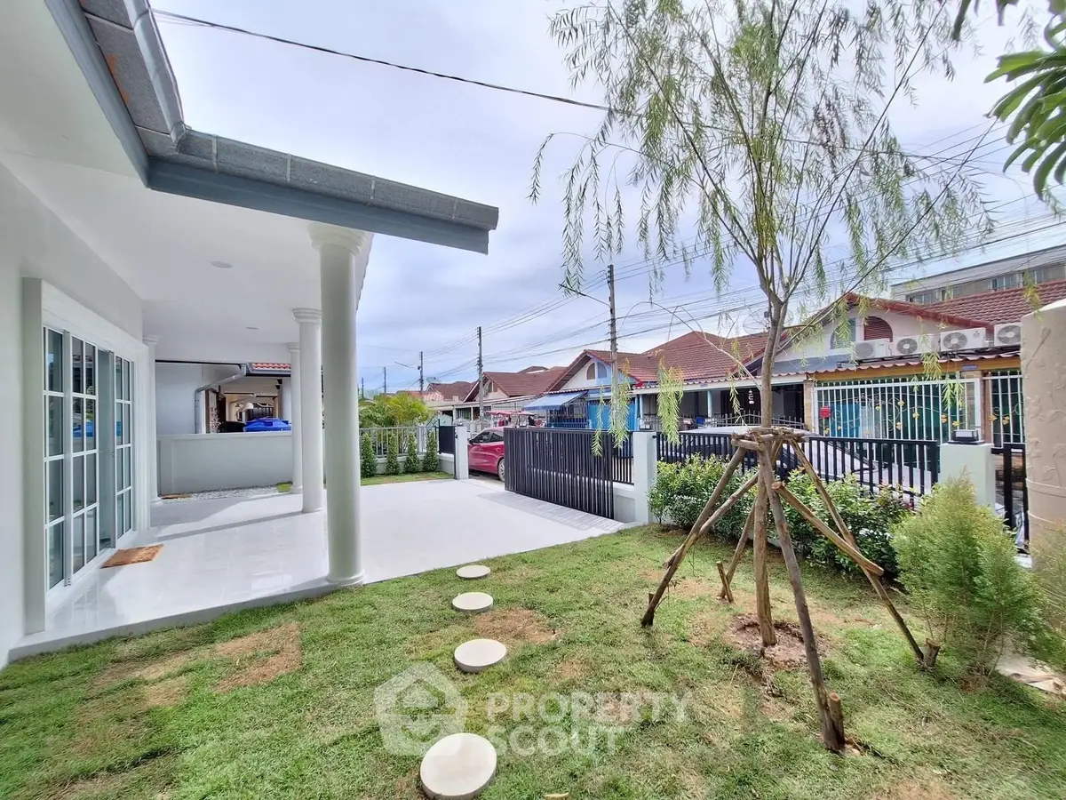 Charming suburban home with lush garden and spacious patio, perfect for outdoor relaxation.