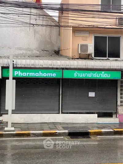 Street view of closed commercial property with signage in urban area.