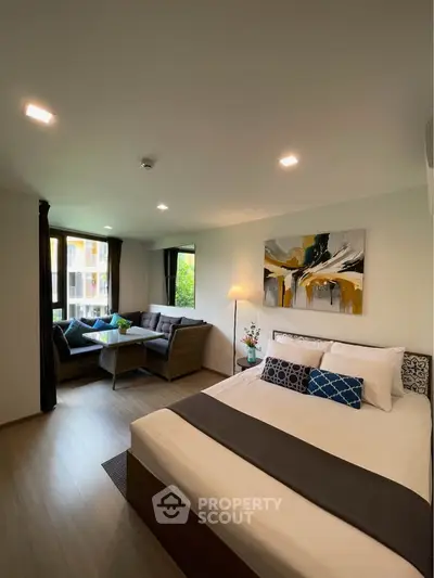 Modern bedroom with cozy seating area and stylish decor