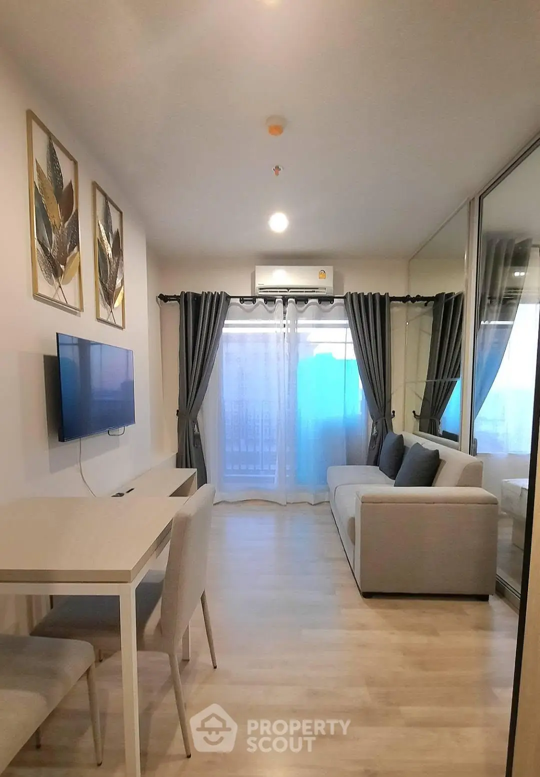 Modern living room with sleek furniture and stylish decor in a cozy apartment setting.
