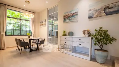 Elegant dining area with modern decor and large window, perfect for entertaining.