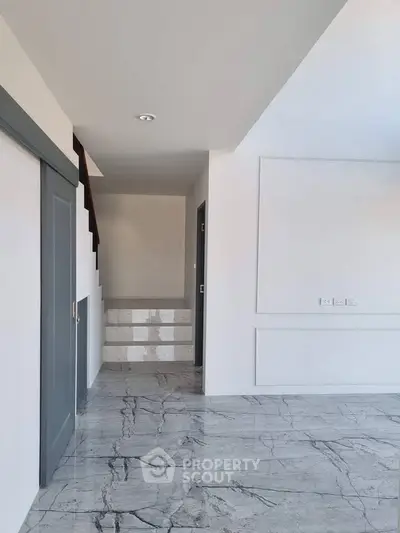 Modern interior with marble flooring and staircase in a stylish home