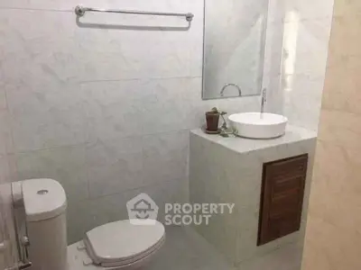 Modern bathroom with sleek white fixtures and minimalist design