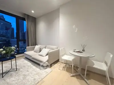 Modern living room with city view, cozy sofa, and stylish decor