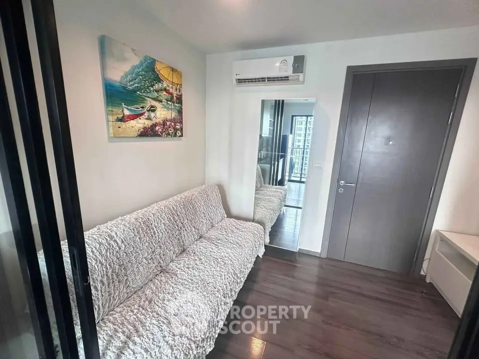 Cozy living room with modern decor and air conditioning in a stylish apartment.