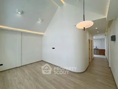 Spacious modern living room with high ceilings and sleek lighting