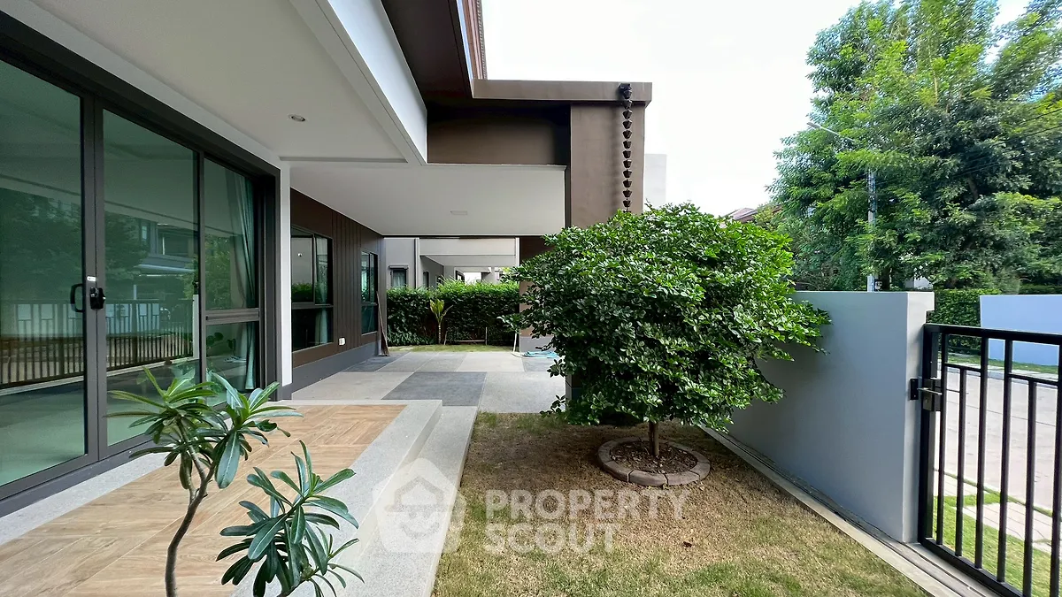 Modern home exterior with lush garden and spacious patio