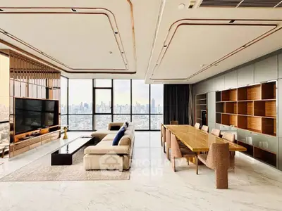 Luxurious modern living room with panoramic city views, elegant furnishings, and spacious open layout.