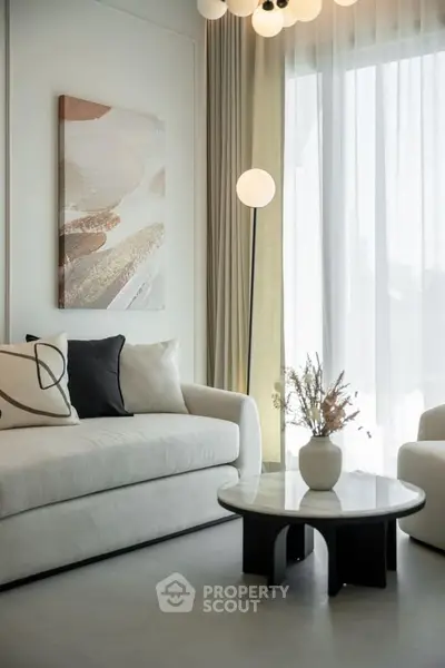 Elegant living room with modern decor, featuring a cozy sofa, stylish floor lamp, and chic coffee table.