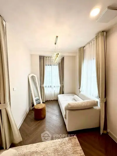 Elegant living room with plush sofa, stylish curtains, and chic lighting.