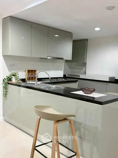 Modern kitchen with sleek cabinetry and breakfast bar seating