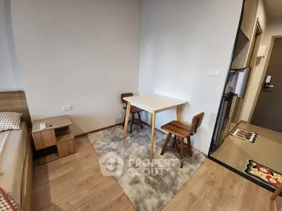 Cozy bedroom corner with small dining table and chairs on a plush rug